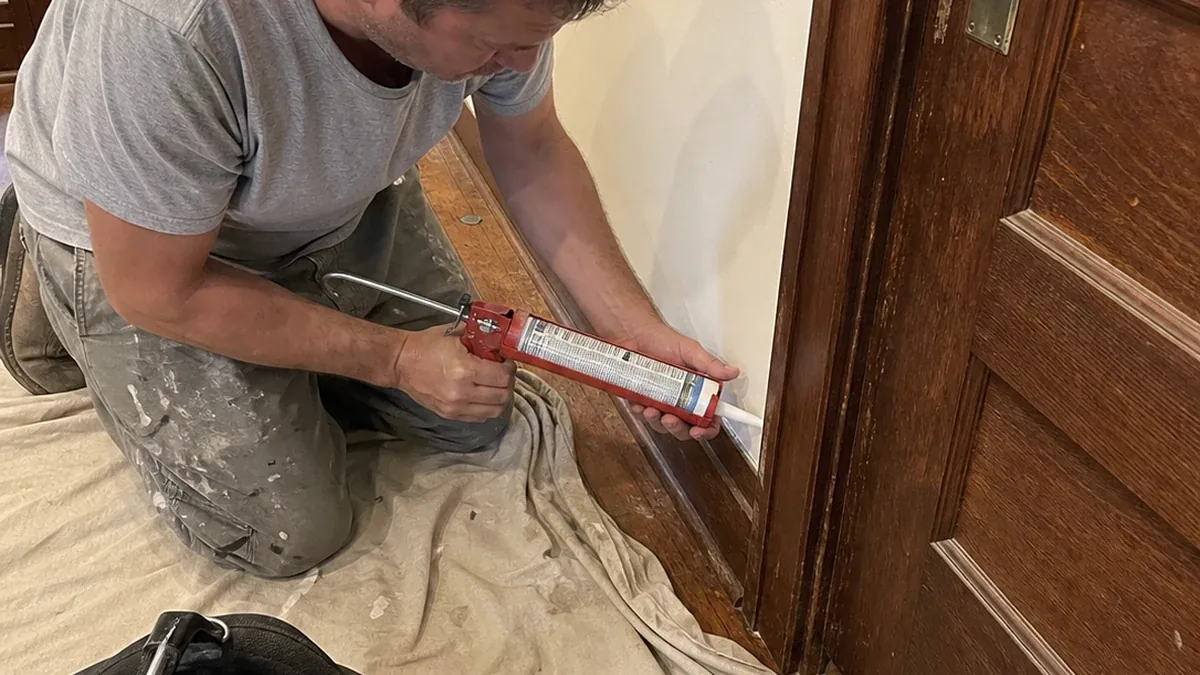 Older door casing and baseboard trim caulking in a Hutchinson Kansas home
